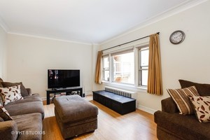 7231 North Ridge Boulevard, Unit 1E Chicago, IL 60645 - Photo 2 of 9 a living room with furniture and a flat screen tv