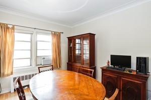 7231 North Ridge Boulevard, Unit 1E Chicago, IL 60645 - Photo 5 of 9 a bedroom with a bed and a flat screen tv