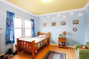 7231 North Ridge Boulevard, Unit 1E Chicago, IL 60645 - Photo 7 of 9 a bedroom with bed and a window