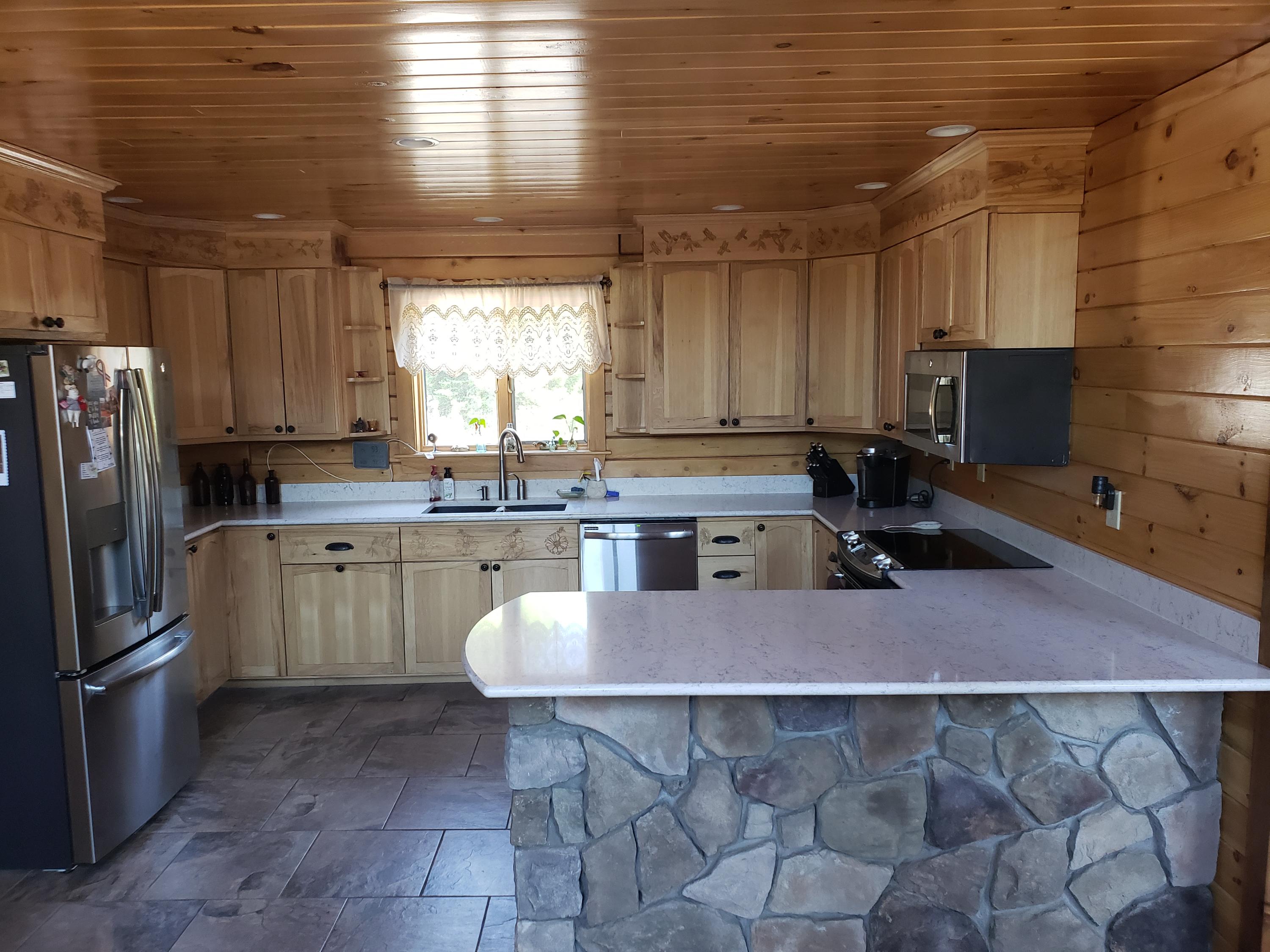 212 Campground Road Livermore Falls, ME 04254 - Photo 22 of 61 Kitchen w/ tile floor and bar seating.