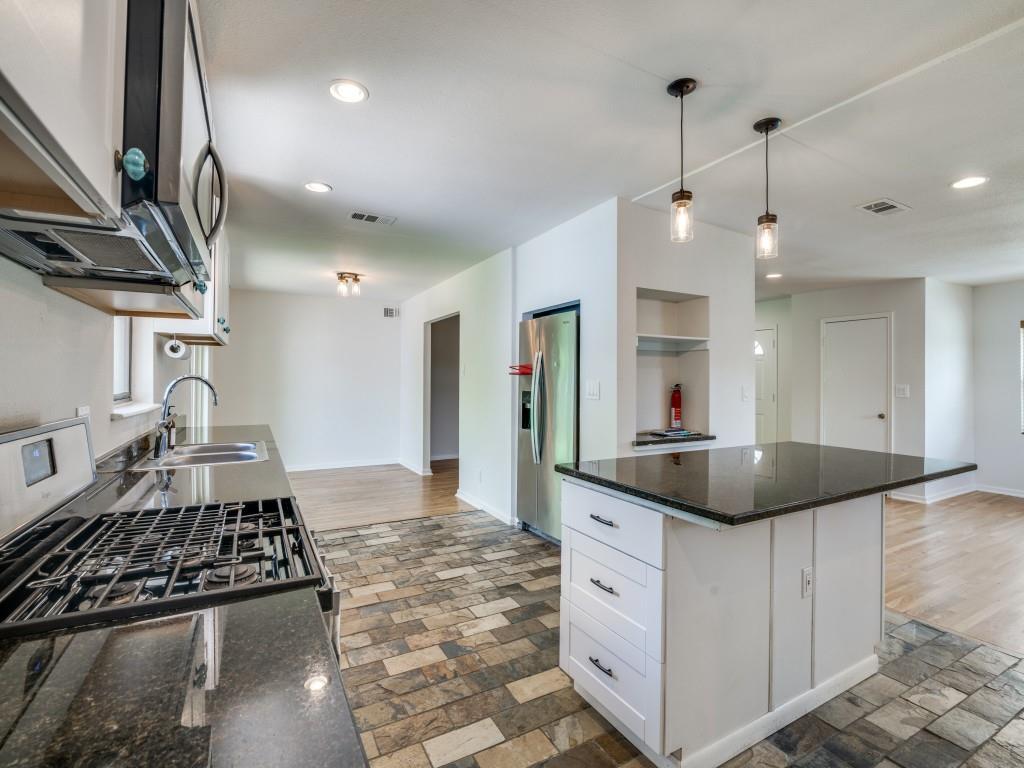 2315 Inadale Avenue Dallas, TX 75228 - Photo 17 of 36 a kitchen with kitchen island granite countertop a sink and a stove