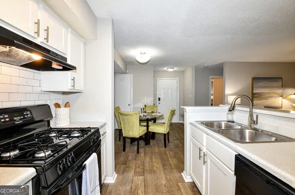a kitchen with a sink appliances and cabinets
