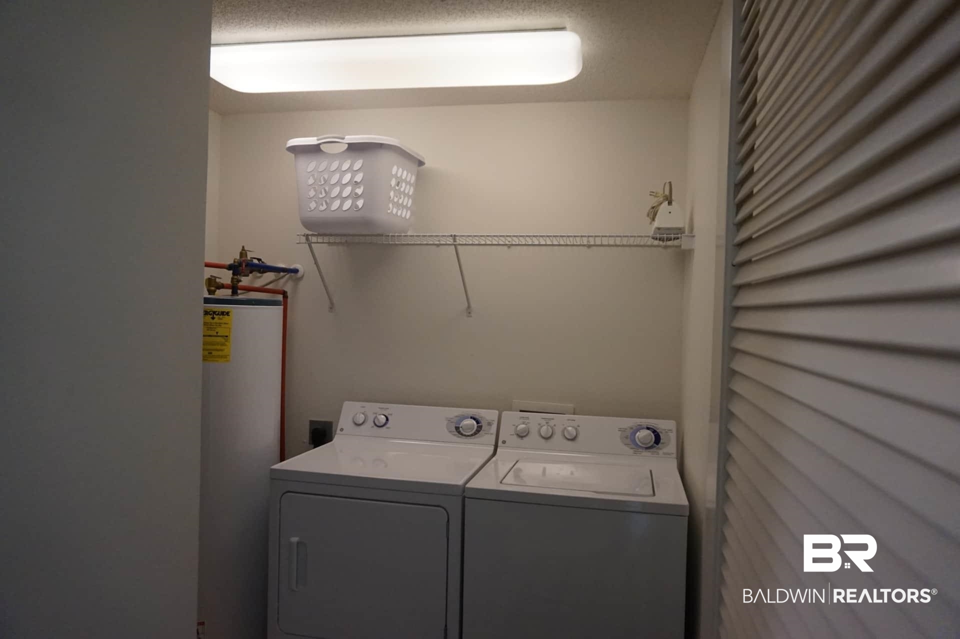 27580 Canal Road, Unit 1431 Orange Beach, AL 36561 - Photo 31 of 73 Laundry room with gas water heater and independent washer and dryer