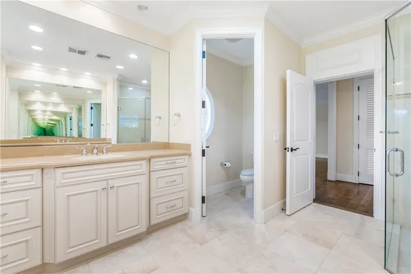 a spacious bathroom with a granite countertop sink mirror and a toilet