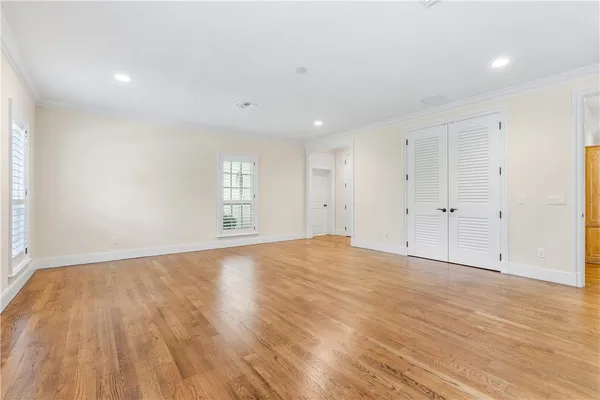 a view of empty room with wooden floor
