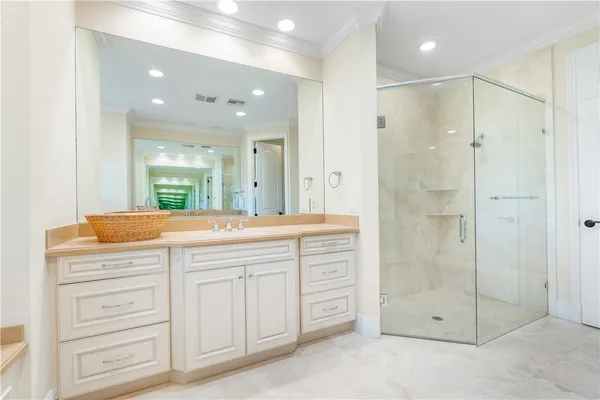 a bathroom with a shower a sink and a mirror