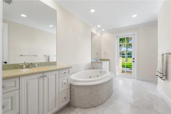 a bathroom with a bathtub sink and mirror