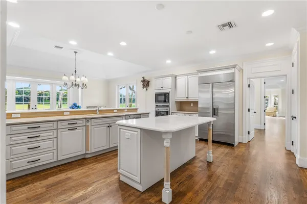 a kitchen with counter top space sink and refrigerator