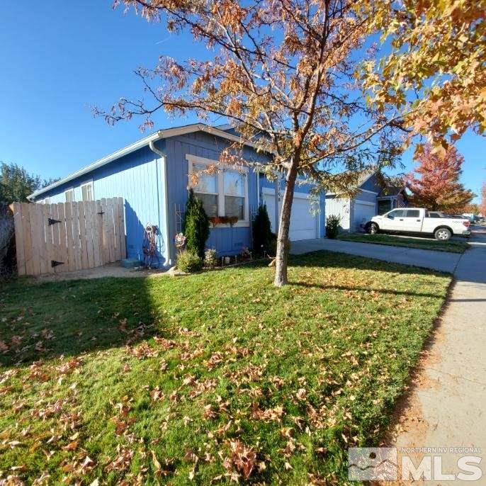 7798 Welsh Drive Reno, NV 89506 - Photo 3 of 18 a view of a house with a large tree and a yard