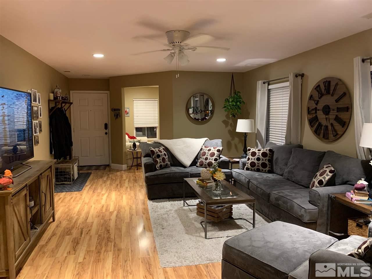 7798 Welsh Drive Reno, NV 89506 - Photo 4 of 18 a living room with furniture and a flat screen tv