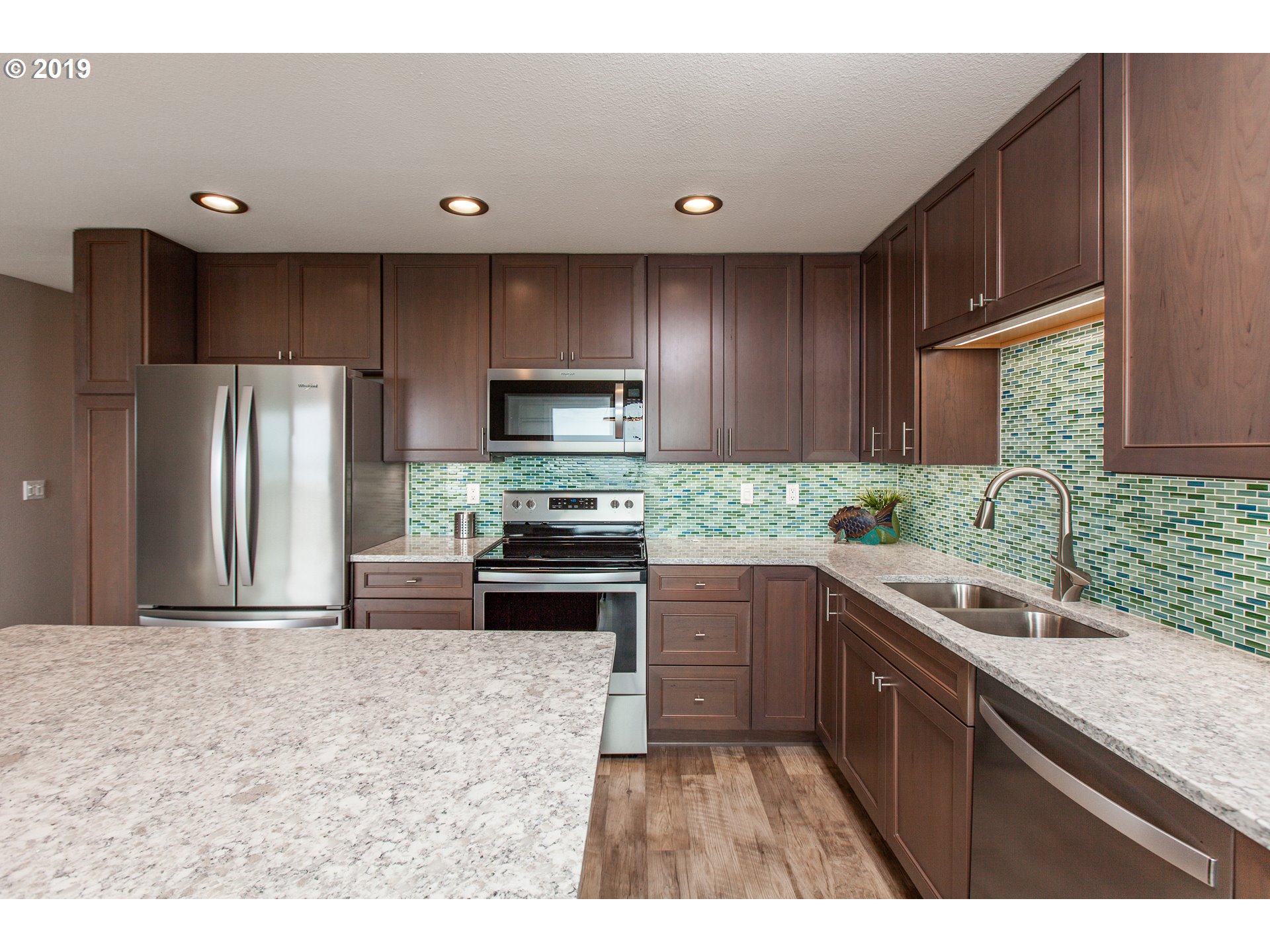 Windward Condo Gearhart, OR 97138 - Photo 11 of 24 a kitchen with granite countertop a refrigerator sink and stove
