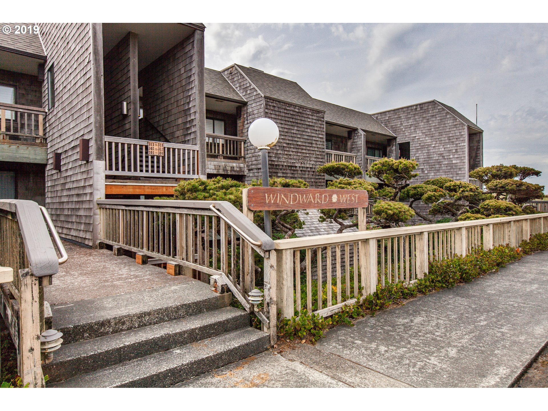 Windward Condo Gearhart, OR 97138 - Photo 8 of 24 a view of a house with wooden fence