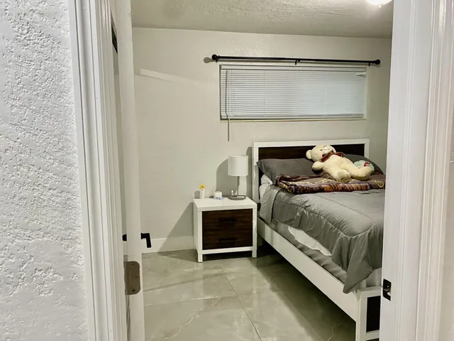 a bedroom with a bed and a mirror