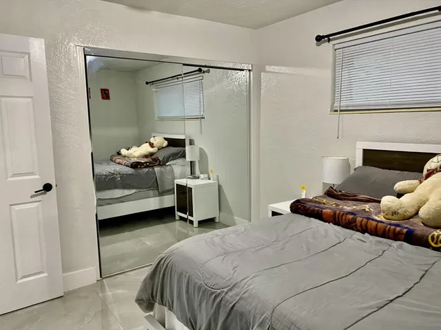 a bedroom with a bed and a window