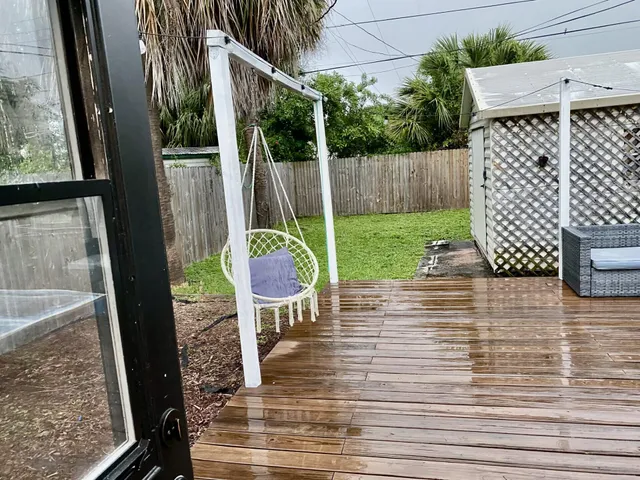 a view of a patio with wooden floor and outdoor seating