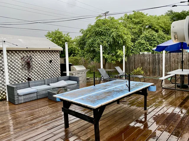 a view of balcony with chairs and umbrella