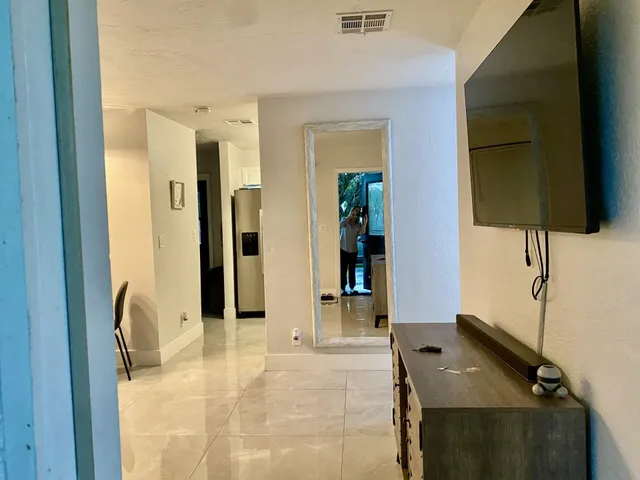 a view of a livingroom with furniture and a dining table