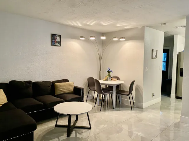 a living room with furniture and a potted plant