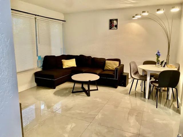 a living room with furniture and a lamp