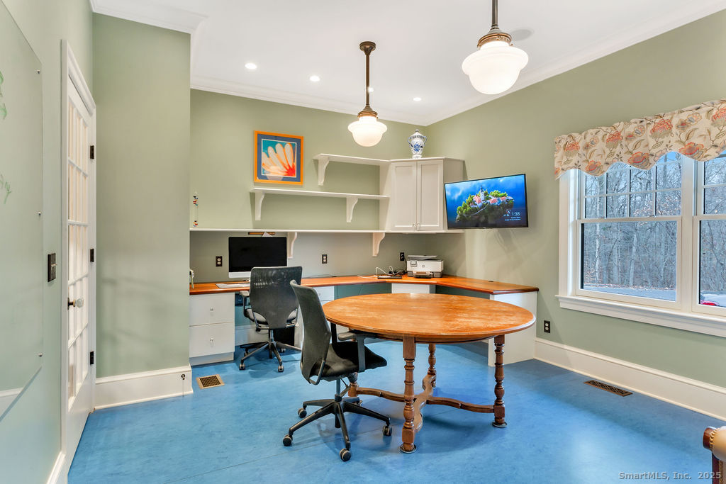 75 Half Mile Road Guilford, CT 06437 - Photo 18 of 39 a view of a kitchen with dining table and chairs