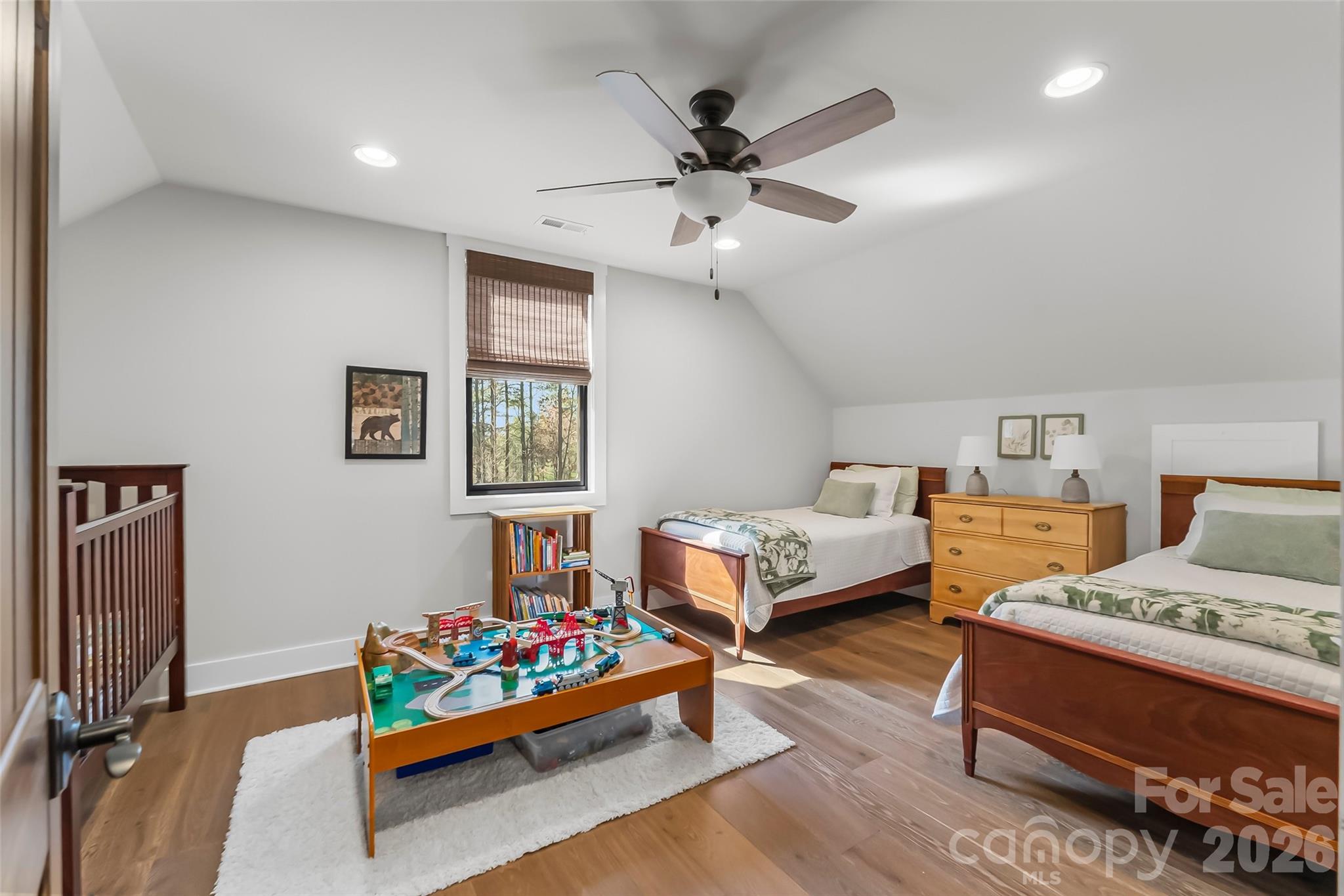 1267 Ten Whigs Ridge Nebo, NC 28761 - Photo 30 of 48 a bedroom with bed and a chandelier fan