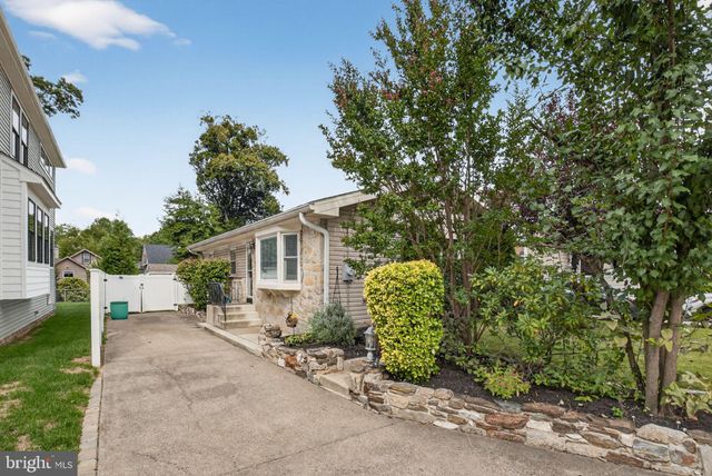 a view of a house with a backyard and a tree