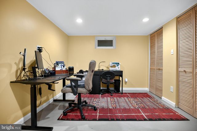 a living room with furniture a rug and a flat screen tv