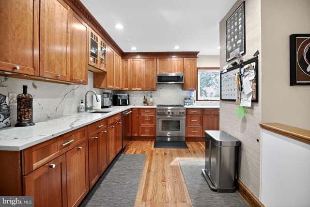 a kitchen with stainless steel appliances granite countertop wooden cabinets a sink and dishwasher