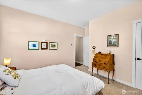 a bedroom with a bed and a chair
