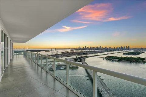 a spacious bedroom with a bed and a flat screen tv
