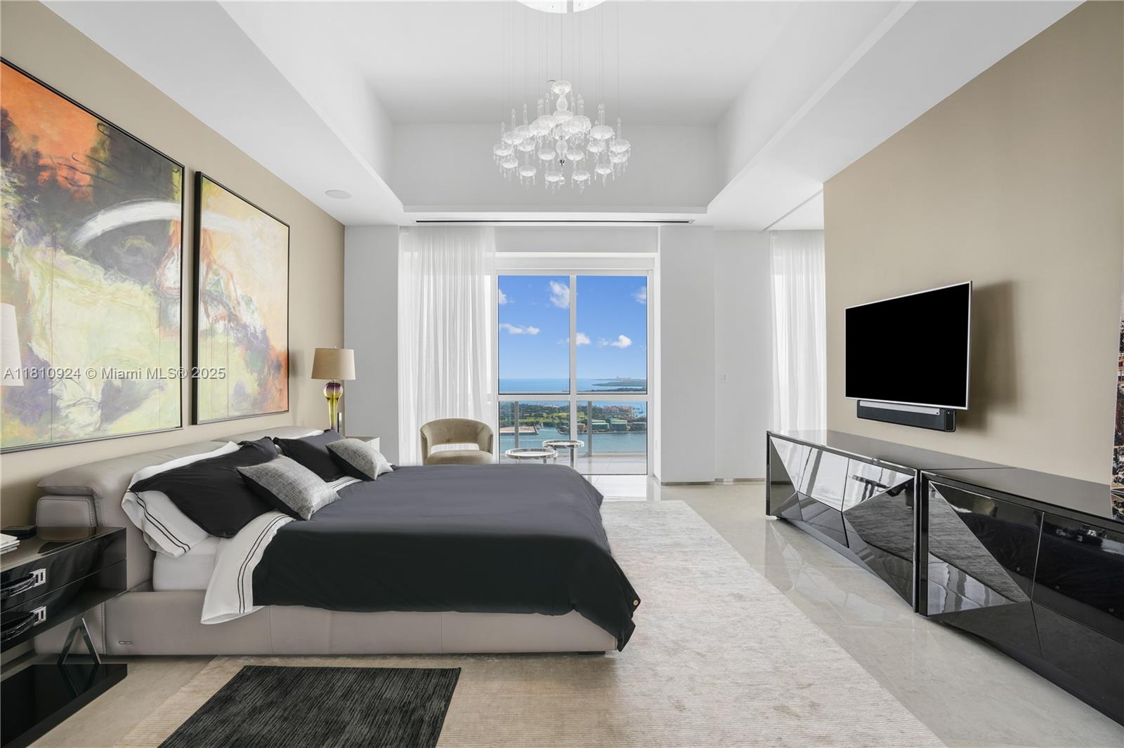 450 Alton Road, Unit PH1 Miami Beach, FL 33139 - Photo 26 of 47 a spacious bedroom with a bed and a flat screen tv
