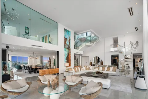 a living room with fireplace furniture and a large mirror