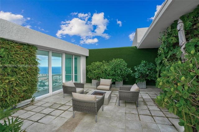 a view of house with deck outdoor seating and yard