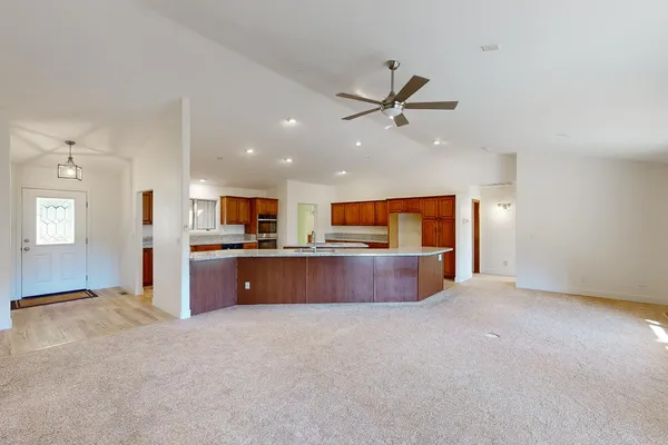 a large kitchen with kitchen island granite countertop a large window