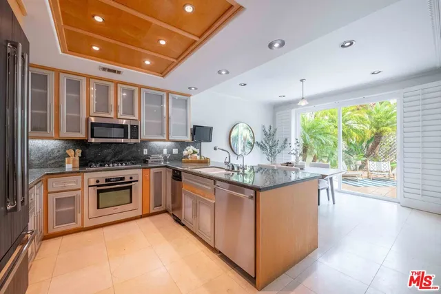a kitchen with stainless steel appliances granite countertop a stove and a sink