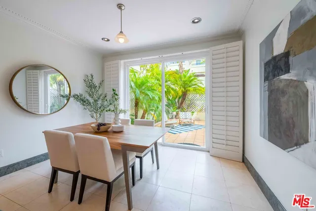 a dining room with furniture and a large window
