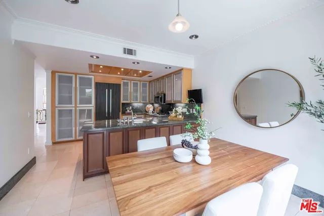 a dining room with wooden floor and chandelier