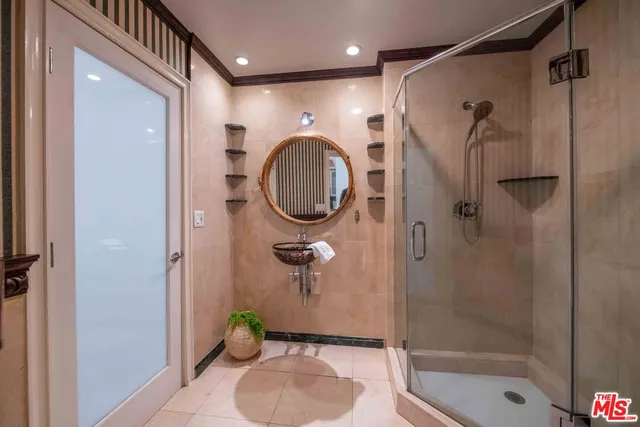 a bathroom with a shower a toilet and a sink