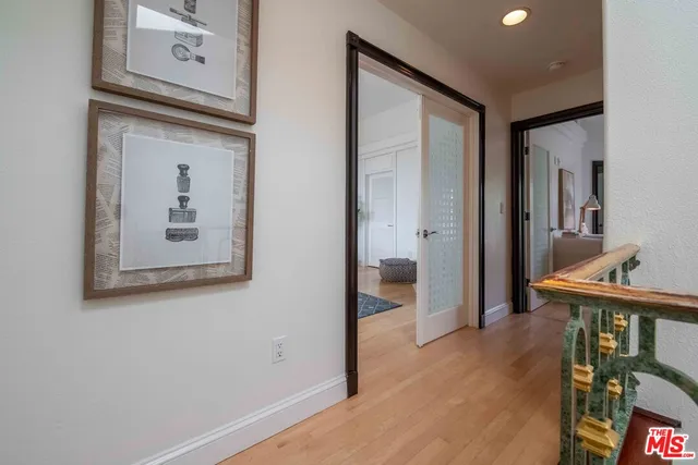 a view of a hallway with wooden floor and entryway