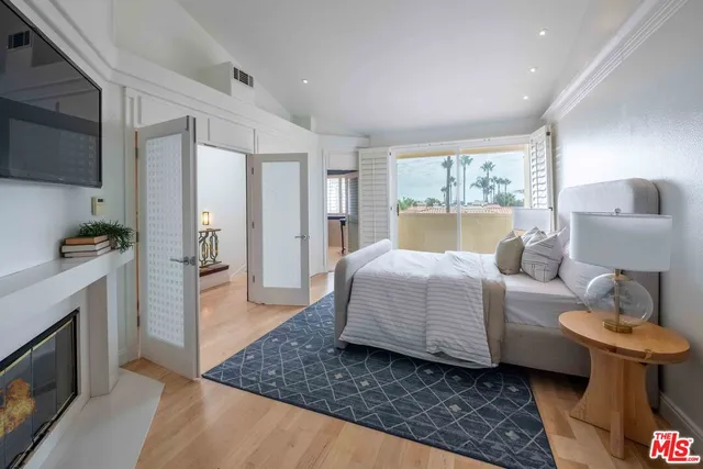 a room with a bed and a television