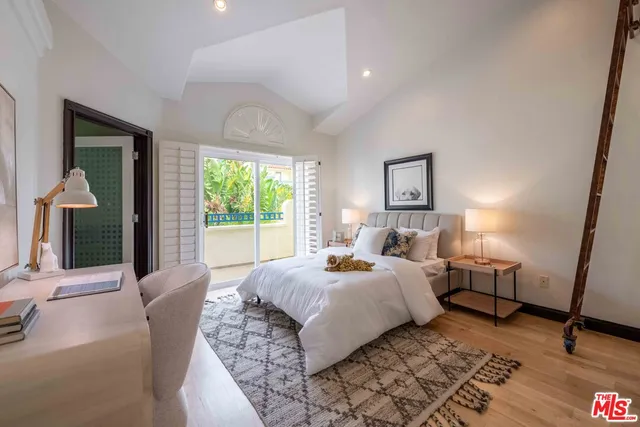 a bedroom with a large bed and a window