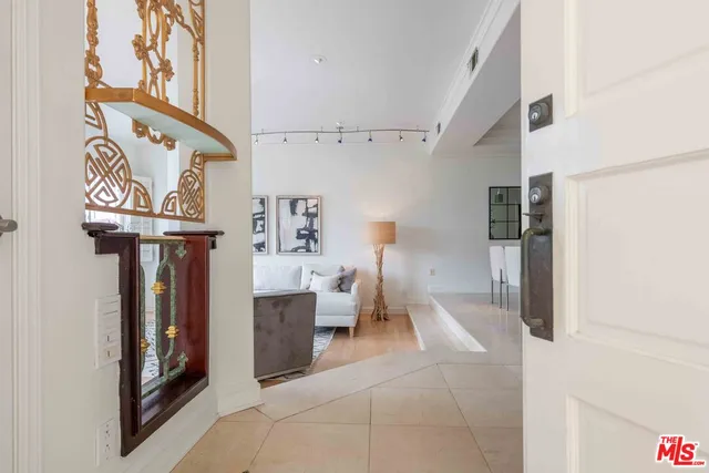 a view of living room filled with furniture and a chandelier