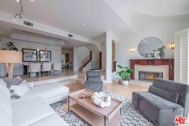 a living room with furniture a fireplace and a table