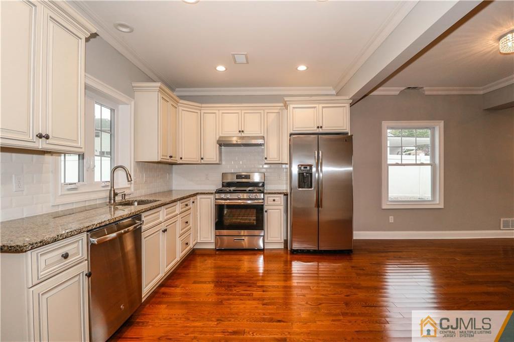 32 Windsor Road Edison, NJ 08817 - Photo 12 of 24 a large kitchen with stainless steel appliances granite countertop a stove a sink and a refrigerator