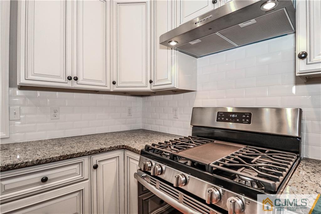 32 Windsor Road Edison, NJ 08817 - Photo 13 of 24 a stove top oven sitting inside of a kitchen