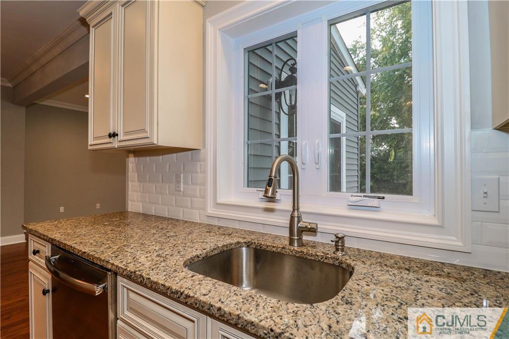 32 Windsor Road Edison, NJ 08817 - Photo 14 of 24 a kitchen with granite countertop a sink and a window
