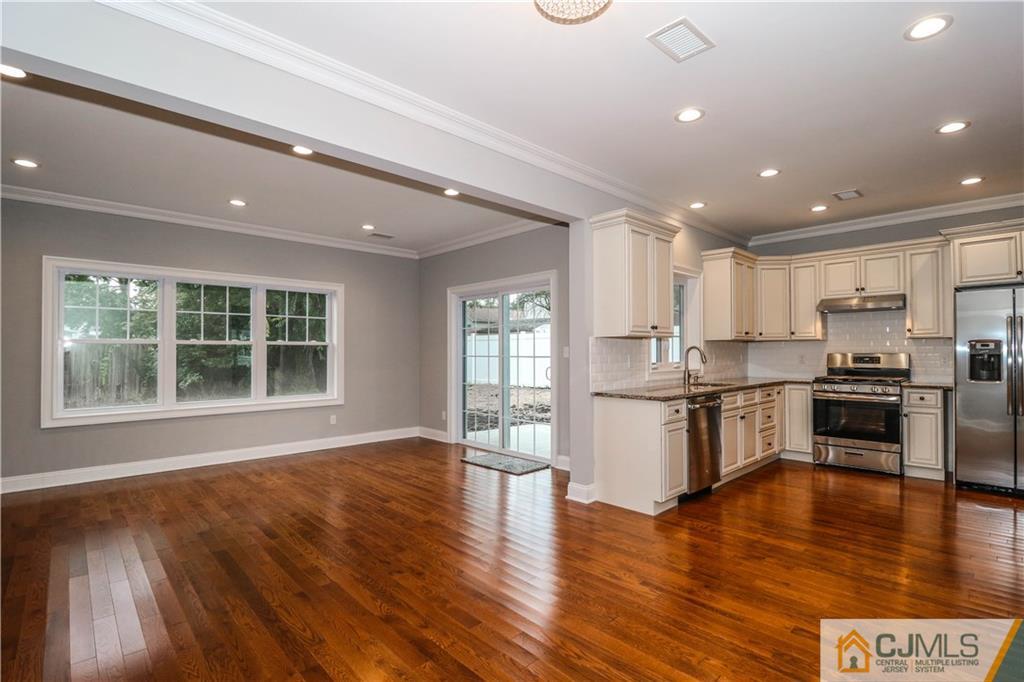 32 Windsor Road Edison, NJ 08817 - Photo 15 of 24 a kitchen with a refrigerator and a stove top oven
