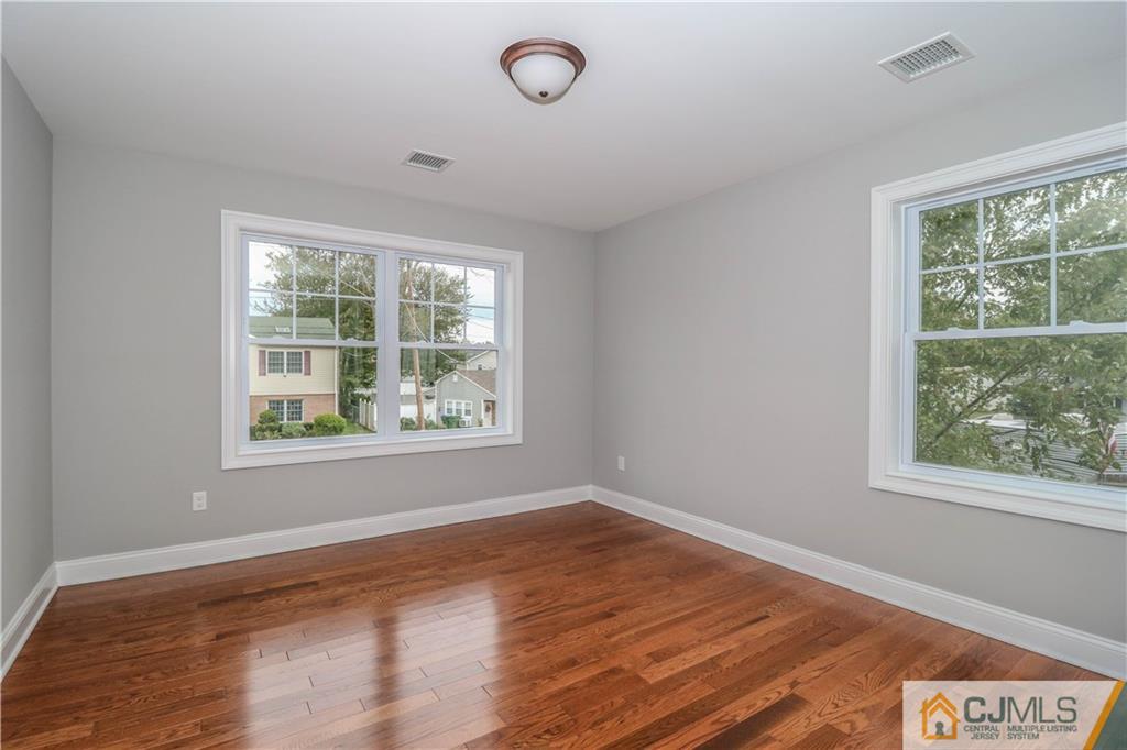 32 Windsor Road Edison, NJ 08817 - Photo 16 of 24 a view of an empty room with wooden floor and a window