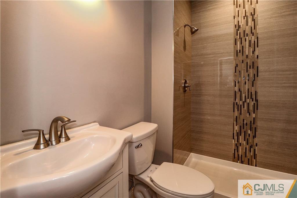 32 Windsor Road Edison, NJ 08817 - Photo 17 of 24 a bathroom with a sink a toilet and shower