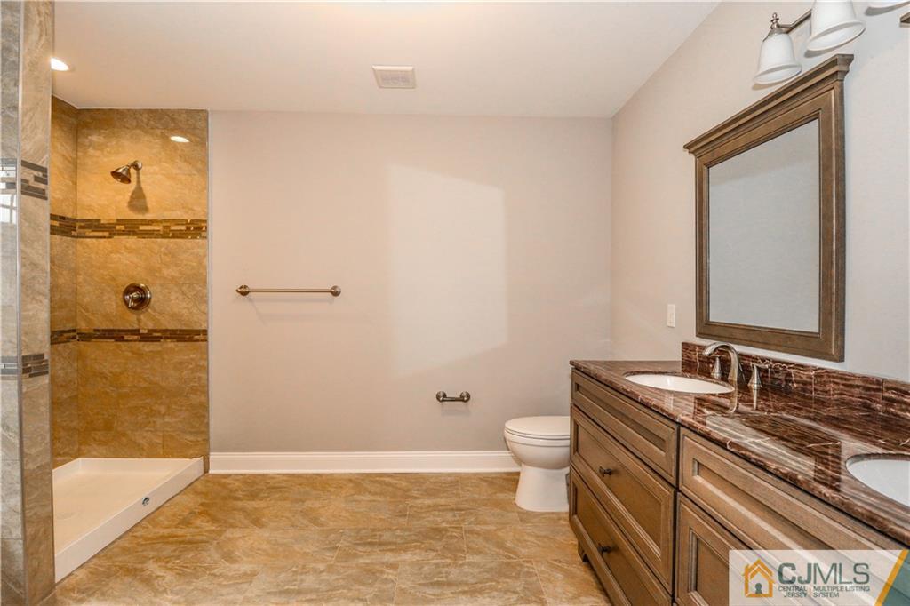 32 Windsor Road Edison, NJ 08817 - Photo 19 of 24 a bathroom with a granite countertop sink toilet and shower